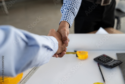 Engineering and businessman shaking hands after successful deal while working in the office center