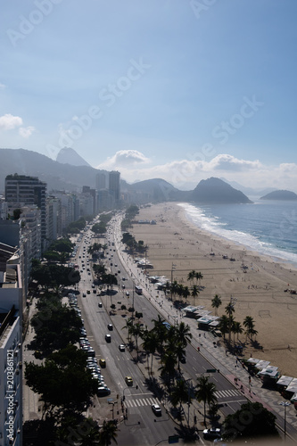 view of Copacabana beachs left side during late afternoon, taken from the rooftop of a hotel, some shadows can be seen on the sandy beach. Rio de Janeiro, Brazil
