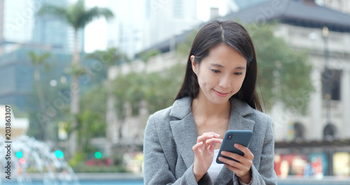 Photography Business woman look at cellphone at outdoor