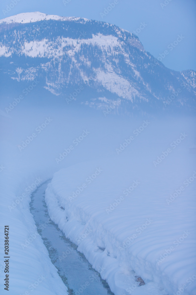 Magical view of Gosau valley in the foggy evening light.Gosau. Austria.