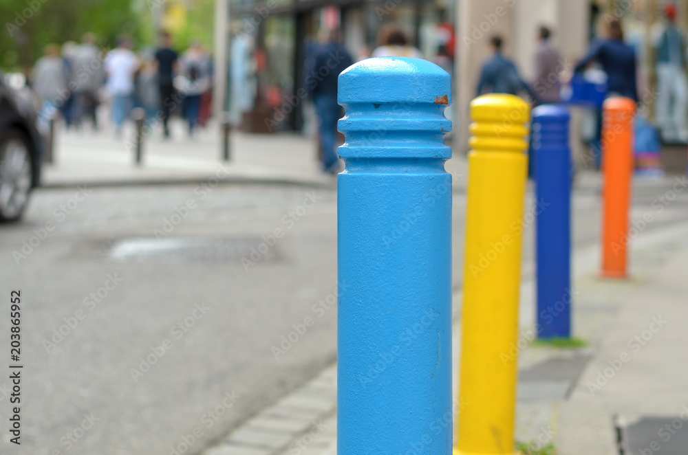 Row of brightly colored bollards on a street