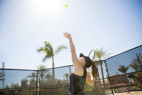 Serving tennis ball on sunny day © AntonioDiaz