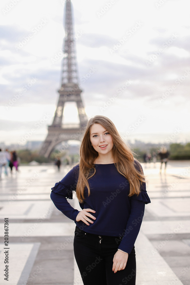 Beautiful female person standing in Eiffel Tower background in Paris ...