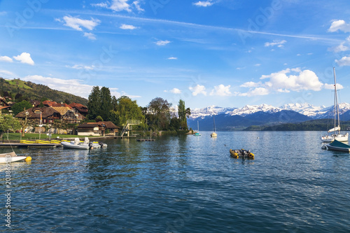 Sailing boats in port at lake Thun infornt of Alps mountain