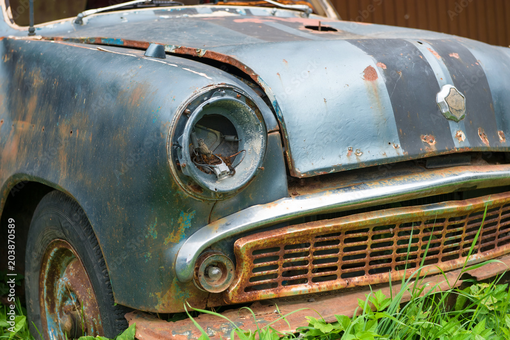 Old rusty overgrown abandoned soviet retro car