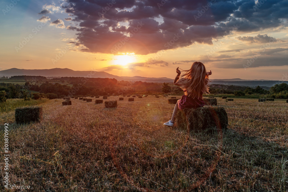 Fototapeta premium Countryside sunset with girl