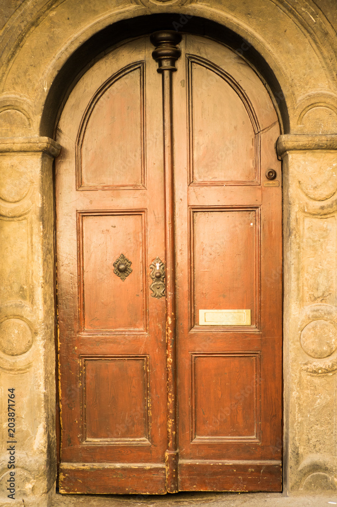 Historical Ornate Wooden Door in a Stone Entry with Arc, Prague, The Czech Republic.