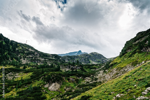 Scenic view of mountains against cloudy sky