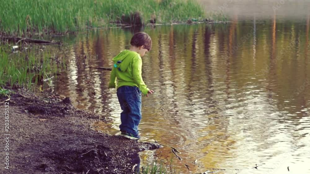 A child playing on the shore of thelake. Walks in the fresh air. A beautiful scenic place. A child playing on the shore of thelake. Walks in the fresh air. A beautiful scenic place.