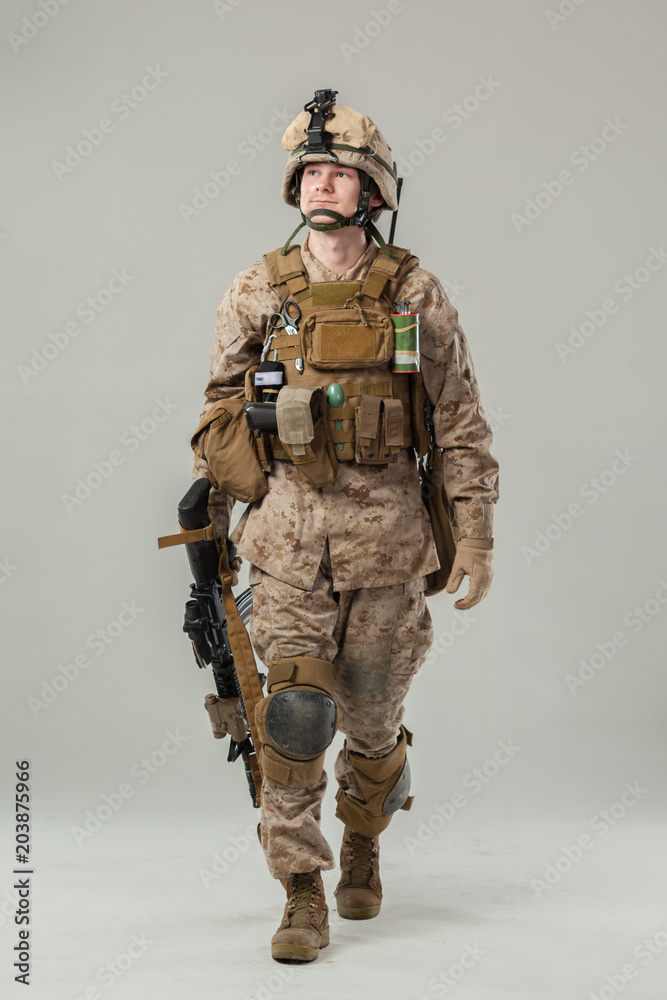 Soldier in camouflage holding rifle Soldier in camouflage holding rifle