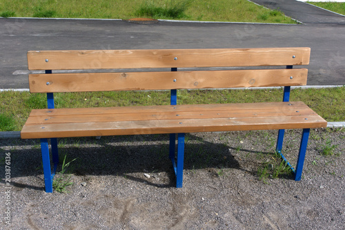 Wooden bench in the city park .
