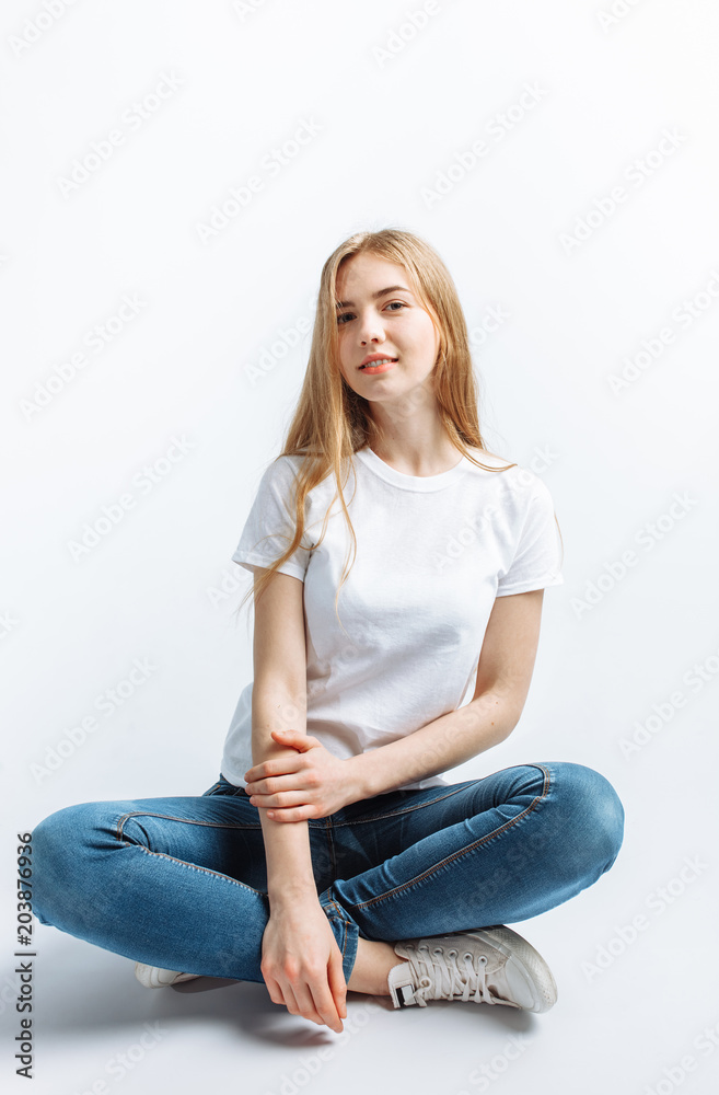 Young girl posing and smiling, on a white background slender blonde Young girl posing and smiling, on a white background slender blonde