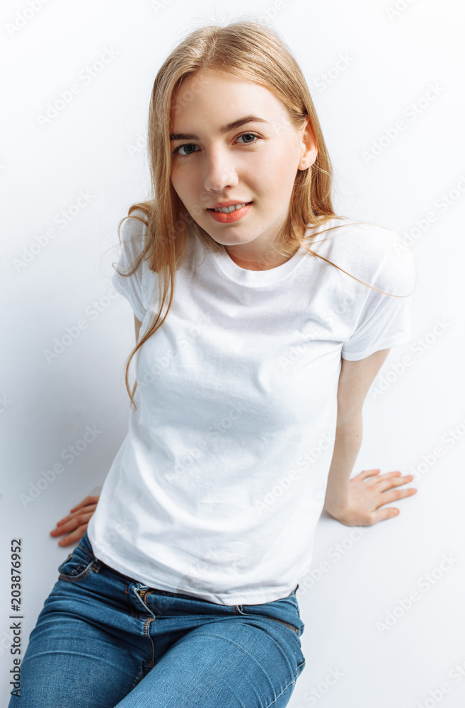Young girl posing and smiling, on a white background slender