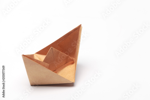 Origami paper boat isolated on white background