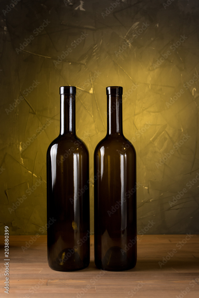 Wine bottles on the table against wooden background
