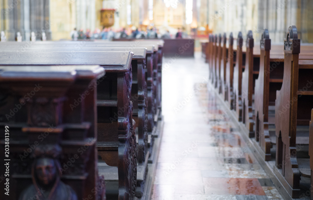 Stained glass windows in small church with wood pews.