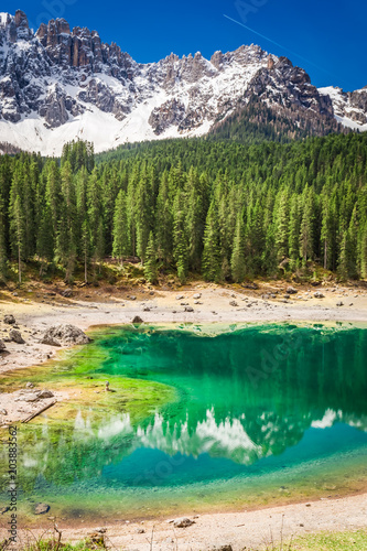 Beautiful and blue mountain Carezza lake in Dolomites, Italy