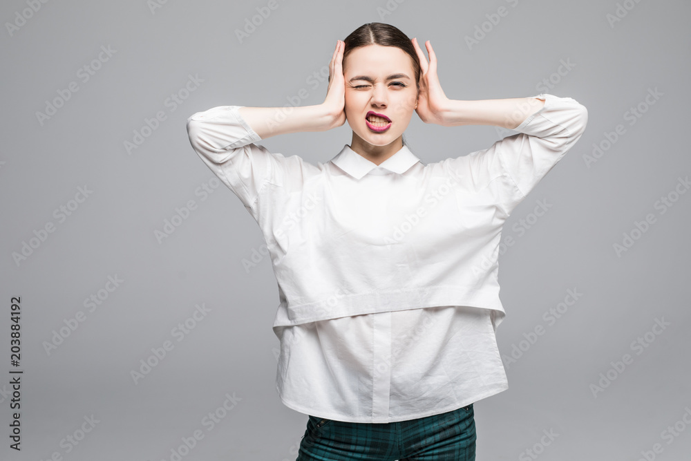 Young businesswoman covering her ears and shouting over white background Young businesswoman covering her ears and shouting over white background