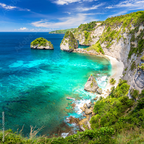 Amazing tropical island with sandy beach, palms trees, reef and rocks