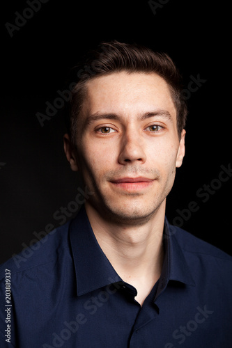 Fashion portrat of young man on black background in studio photo