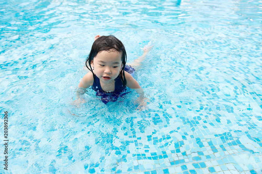 Portrait of Asian little baby girl playing in swimming pool
