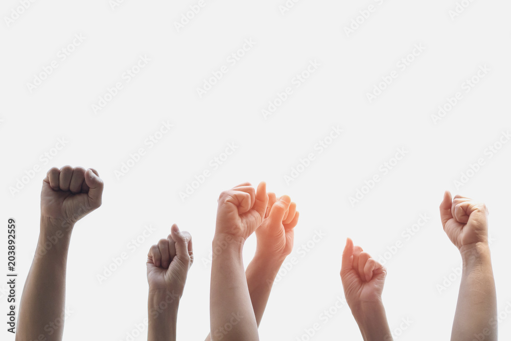 Group people of fists raised with sunlight