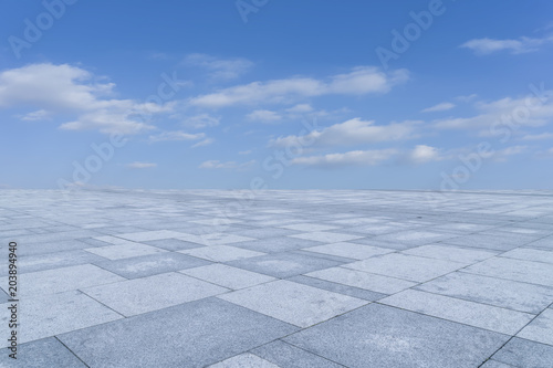 Empty square floor tiles and beautiful sky landscape