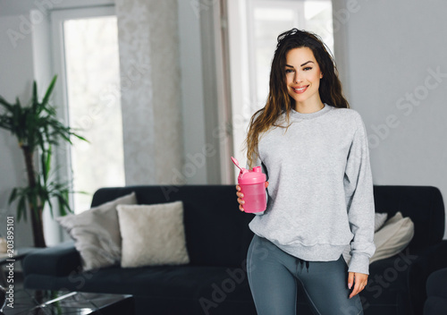 Fitness woman drinking shake