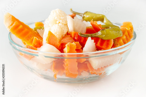 Assorted pickles vegetables carrot, chilli, cauliflower in glass bowl. Top view. Isolated. Copy space.