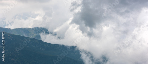 Mountains surrounded by clouds. Close up