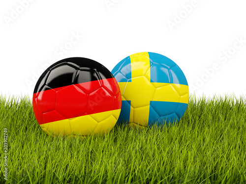 Germany vs Sweden. Soccer concept. Footballs with flags on green grass