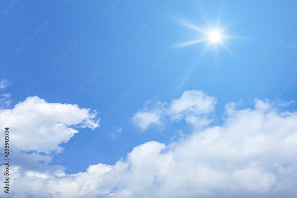 bright blue sky with sun and clouds background