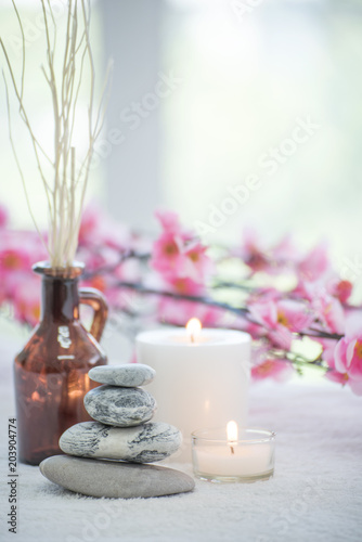 Spa accessories still life with aromatic candle, stone, flower, towel.