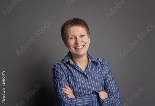 Happy laughing middle-aged woman in blue shirt