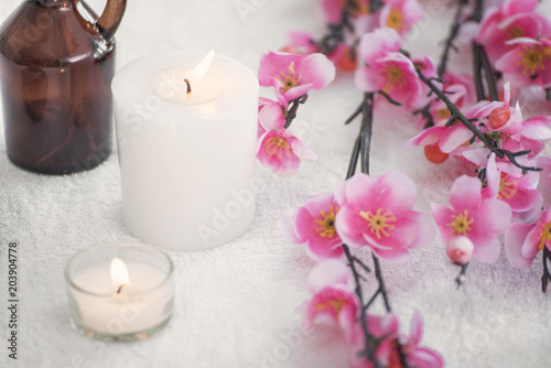 Spa accessories still life with aromatic candle, flower, towel. panoramic banner with copy space.