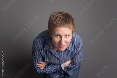 Happy smiling middle-aged woman in blue shirt
