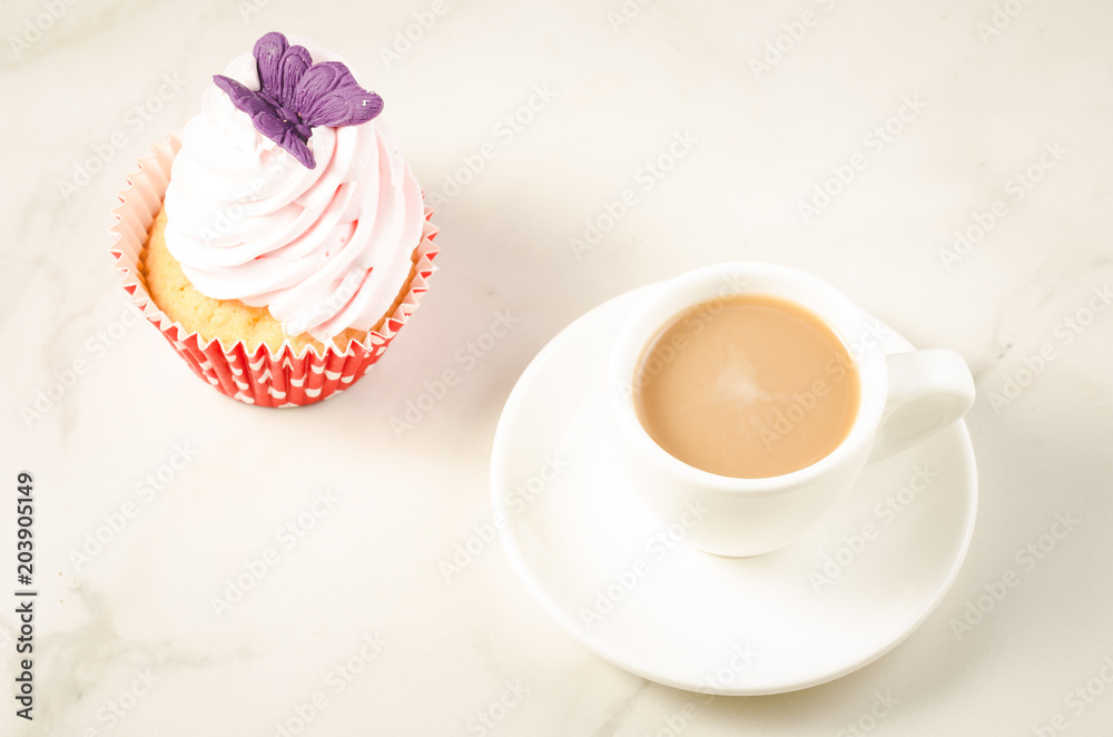 cappuccino white cup and fresh cake with butterfly/cappuccino white cup and fresh cake with butterfly on a white marble background. Top view cappuccino white cup and fresh cake with butterfly/cappuccino white cup and fresh cake with butterfly on a white marble background. Top view