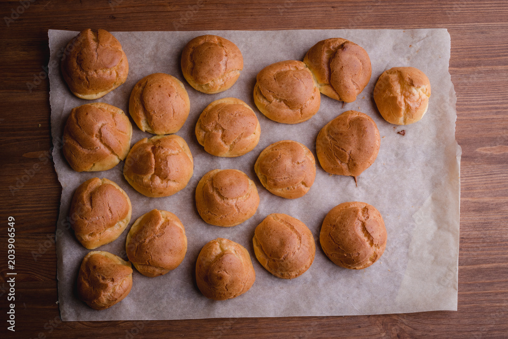 fresh eclairs on parchment wooden table fresh eclairs on parchment wooden table
