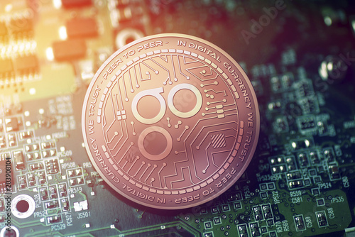 shiny copper OMISEGO cryptocurrency coin on blurry motherboard background photo