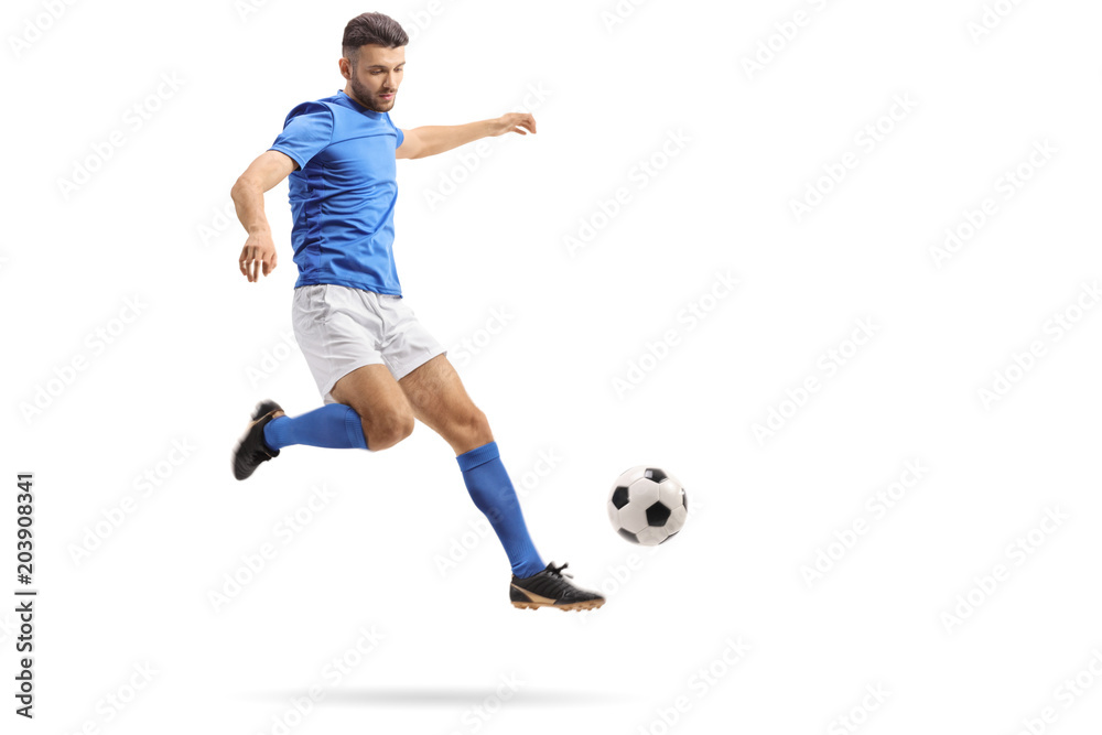 Fototapeta premium Soccer player in mid-air kicking a football
