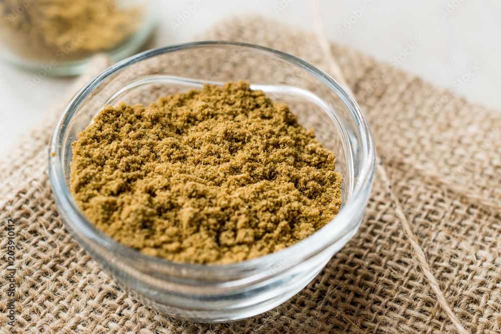 Cumin Powder in Glass Bowl with sack Cumin Powder in Glass Bowl with sack