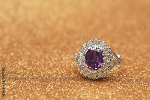 purple gemstone on diamond ring