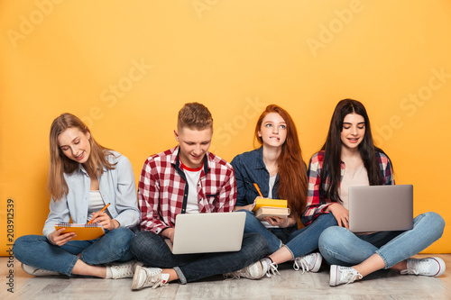 Group of young smart school friends doing homework