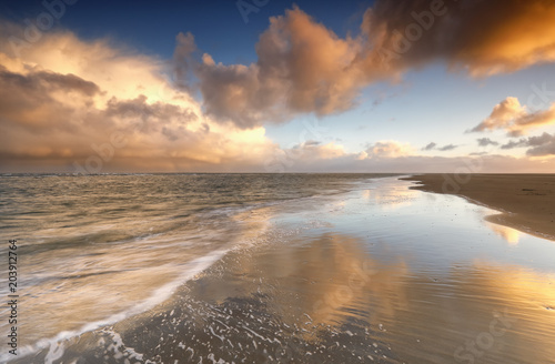 beautiful gold sunrise on North sea coast © Olha Rohulya