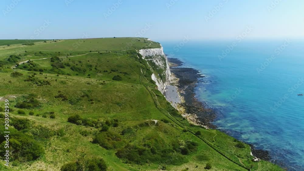 Aerial view of famous white cliffs of Dover, clear blue sky - English Channel, England, Great Britain from above, 4k UHD Aerial view of famous white cliffs of Dover, clear blue sky - English Channel, England, Great Britain from above, 4k UHD
