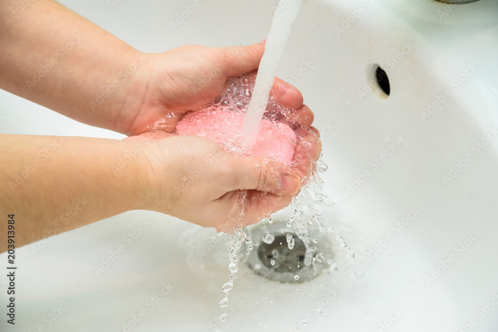 Fototapeta premium Woman washing hands with soap in sink