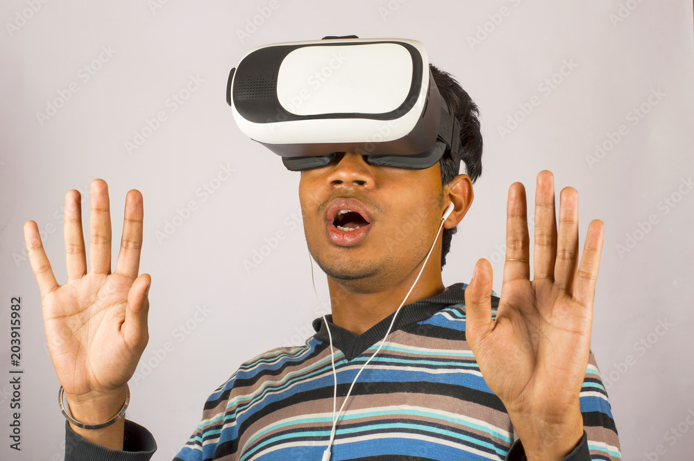 Scared young boy with virtual reality goggles and enjoying in scary 3D VR video