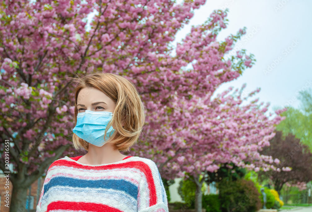 Allergy. Woman wearing protect mask from pollen allergy