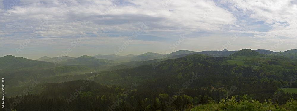 Fototapeta premium luzicke hory mountains wide panorama, skyline view from hill stredni vrch, green forest and blue sky, white clouds background