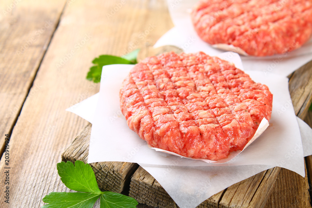 Raw minced meat for home made grill burgers cooking with spaces and herbs. Raw minced meat for home made grill burgers cooking with spaces and herbs.